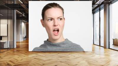 young woman with open mouth looks surprised Wall mural