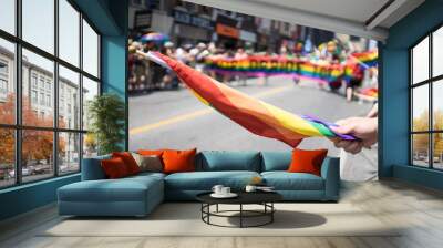 People participating in the World Pride Parade in Toronto. Spectators can be seen beside the path holding a rainbow flag. LGBTQ Wall mural