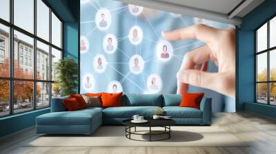 Businessman touching a social network and human icon on a virtual screen, with female icons connected to male figures for an online community manager or team-building concept  Wall mural