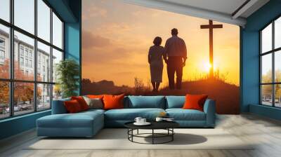 Senior Couple Silhouette on Hill Near Christian Cross During Sunset Wall mural