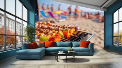 Summer bbq concept image with skewers on a hot barbecue on the beach with people in background Wall mural