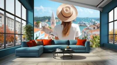 Woman in a Straw Hat Admires the Breathtaking Coastal View, Perfect for Travel Posters and Brochures Wall mural