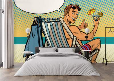 Handsome man resting on the beach Wall mural