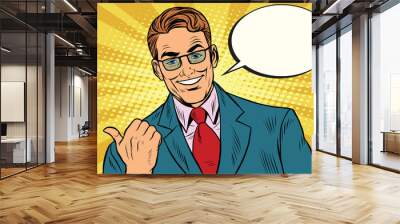 Smiling businessman showing big finger to the left Wall mural