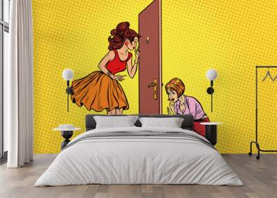 Two women spy on each other through the door Wall mural