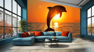 a dolphin jumping in front of a setting sun Wall mural