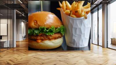 delicious burger with lettuce peeking out, fries overflowing from cup Wall mural