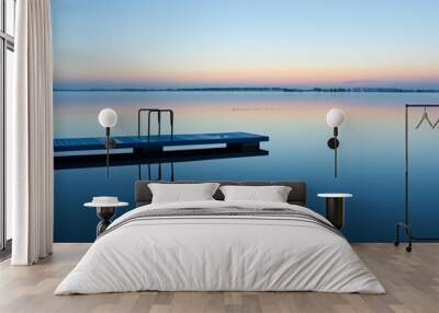 empty diving board over calm water at sunrise Wall mural