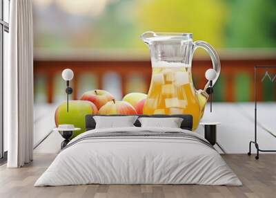 fresh apple cider in pitcher with whole apples Wall mural