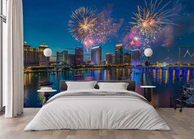 Fireworks over downtown Tampa skyline at night during celebration event with reflection on water. Wall mural