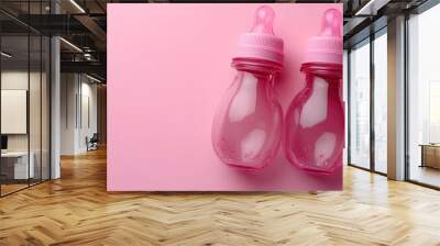 Two Pink Baby Bottles on a Pink Background Wall mural