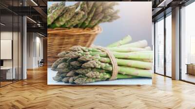 Asparagus. Fresh raw organic green Asparagus sprouts closeup. Basket and bunch n the table. Healthy vegetarian food. Raw vegetables, market. Healthy eating concept, diet, dieting.  Wall mural