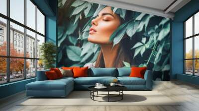 Beautiful fashion model girl enjoying nature, breathing fresh air in summer garden over Green leaves background. Harmony concept Wall mural