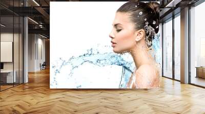 Beautiful model woman with splashes of water in her hands Wall mural