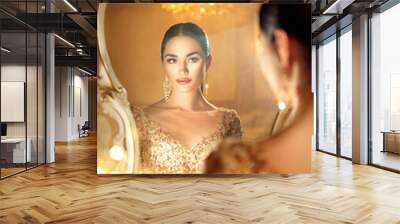 Beauty glamour lady looking in the mirror. Gorgeous woman in beautiful evening dress in luxurious style room Wall mural