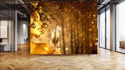 Beauty Golden Christmas Woman with champagne. Beautiful girl drinking sparkling wine, over glowing holiday background. Xmas, New Year celebration. Wall mural