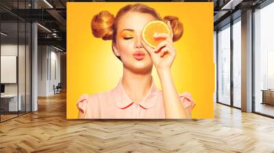 Beauty model girl takes juicy oranges Wall mural