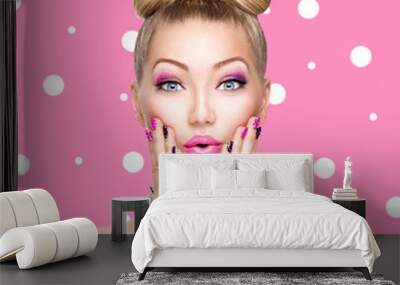 Beauty model girl with bow hairstyle over polka dots background Wall mural