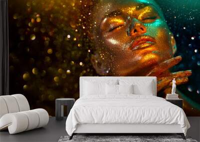 Fashion model woman skin face in bright sparkles, colorful neon lights, beautiful sexy girl portrait. Trendy glowing gold skin make-up. Art design make up. Glitter metallic shine golden green makeup Wall mural