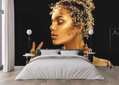 Gold woman skin. Beauty fashion model girl with golden makeup, hair and jewellery on black background Wall mural