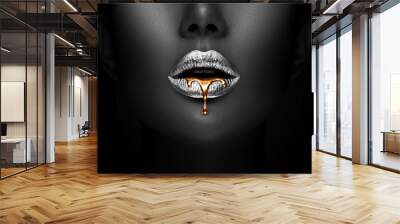 Golden lipstick closeup. Liquid metal dripping from silver lips. Beautiful makeup. Sexy lips, bright liquid paint on beauty model girl's mouth, close-up. Lipstick. Wall mural