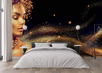 golden woman. beauty fashion model girl with golden make up, hair and jewellery on black background Wall mural