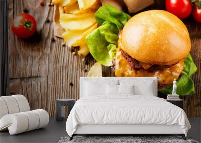 Hamburger with fries on wooden table Wall mural