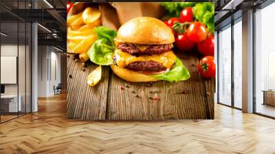 Hamburger with fries on wooden table Wall mural