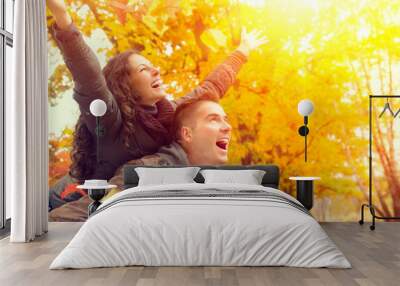 happy couple in autumn park. fall. family having fun outdoors Wall mural