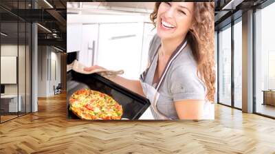 Happy Young Woman Cooking Pizza at Home Wall mural