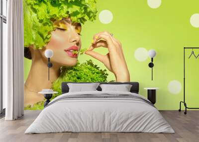 Healthy eating, diet. Beautiful healthy girl eating raw vegan food and smiling. Beauty young fashion woman eats green fresh lettuce salad leaf, organic vegetables. Vegetarian. On green background Wall mural