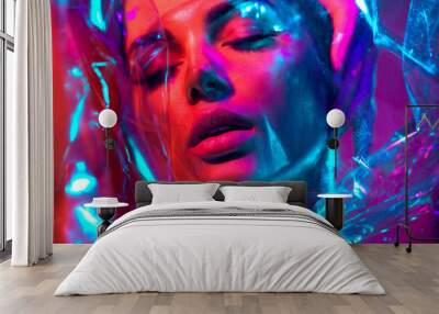 High Fashion model girl in colorful bright neon lights posing in studio through transparent film. Portrait of beautiful young woman in UV. Art design colorful make up. On colourful vivid background Wall mural