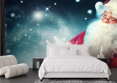 portrait of happy santa claus with magic light in his hands Wall mural