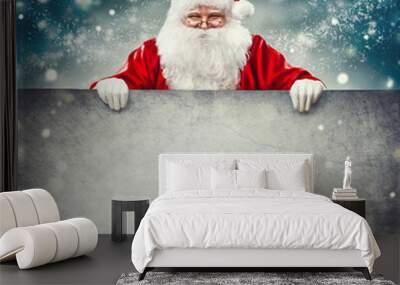 Santa Claus holding blank advertisement banner background with copy space for text Wall mural