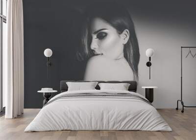 Sexy young woman black and white portrait. Seductive young woman with long hair posing in spotlight Wall mural