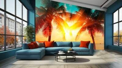 Sunset beach with tropical palm tree over beautiful sky. Palms and beautiful sky background. Tourism, vacation concept backdrop. Palms silhouettes over orange sun Wall mural