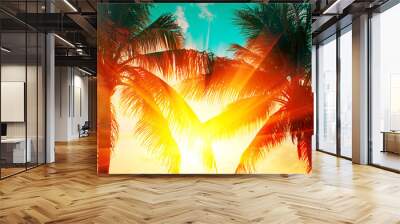 Tropical palm tree over sunset sky. Palms and beautiful sky background. Tourism, vacation concept backdrop. Palms silhouettes over orange sun Wall mural