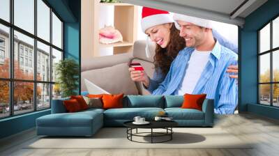 Young couple with laptop and credit card buying online Wall mural