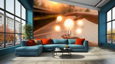 Hand of holding illuminated light bulb,innovation inspiration concept.business idea. Wall mural