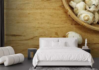 Champignon mushrooms on wood background Wall mural