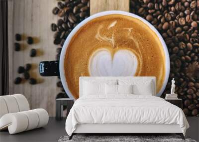 Heart coffee latte art milk foam on cup and coffee beans Wall mural