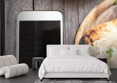 Indian naan bread with smart phone Wall mural