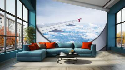 aircraft Wing on cloudscape and blue sky Wall mural