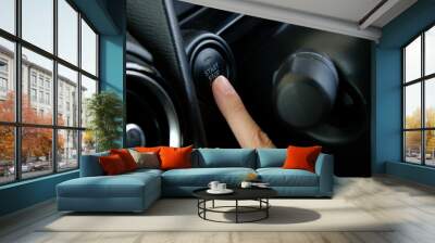 Woman starts the car engine with start-stop button. Modern car interior Wall mural