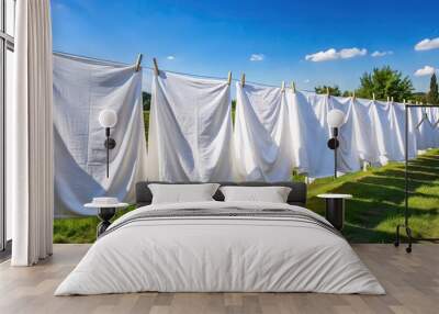 Freshly laundered white bed sheets drying on a clothesline from high angle Wall mural