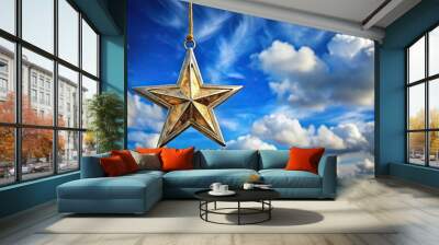 Hanging star ornament against cloudy blue sky background at tilted angle Wall mural