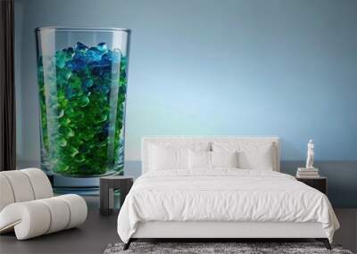 Medium shot of crystals in glass of water against green blue background Wall mural