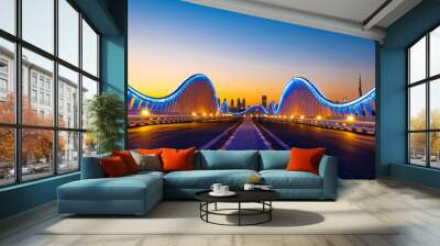 Beautiful view of Meydan Bridge in Dubai. Modern artistic bridge in Dubai. Night architectural shot of a bridge with curvy blue lights. Wall mural