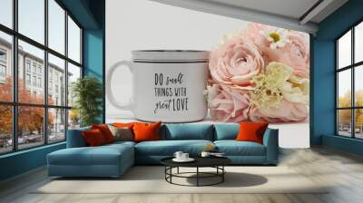 inspirational love message on a white and grey coffee mug next to a pastel bouquet of flowers on a white background  Wall mural