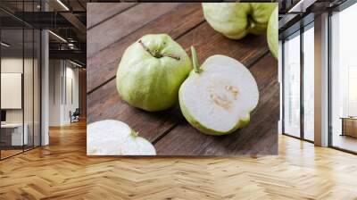 Guava fruits on a wooden table. Malaysian people are called Jambu Batu. Wall mural